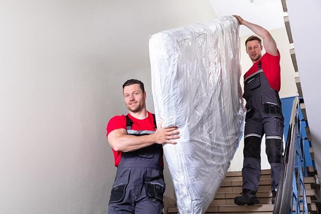 bed frame being cleared as old box spring is removed in Berlin